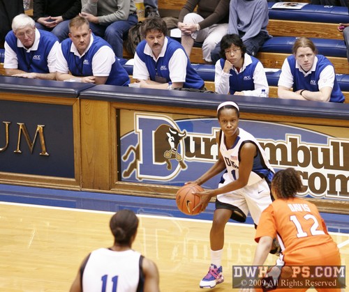 A jury box of sideline officials watches Chelsea Hopkins pass to Black in the high post