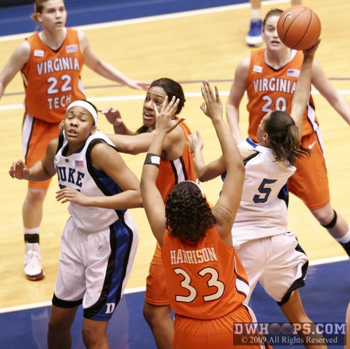 Krystal Thomas absorbs a forearm shiver from Brittany Gordon as Jasmine Thomas goes to the rack