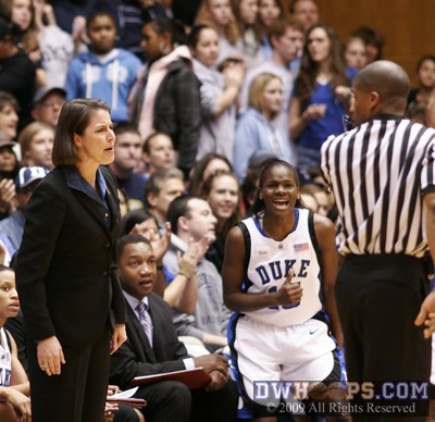 Duke head coach Joanne P. McCallie questions Eric Brewton's call as Bridgette Mitchell cheers on her teammates