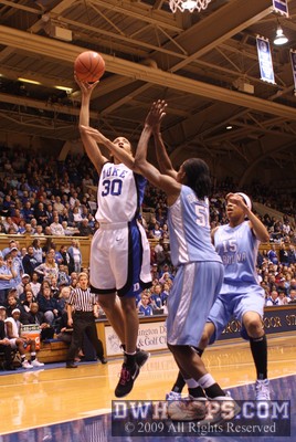 Carrem Gay attempts a layup over Jessica Breland